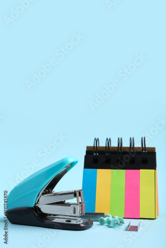 Blue stapler with colorful ...