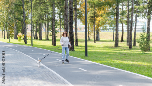 Wallpaper Mural Caucasian woman roller skating with her jack russell terrier dog in park.  Torontodigital.ca