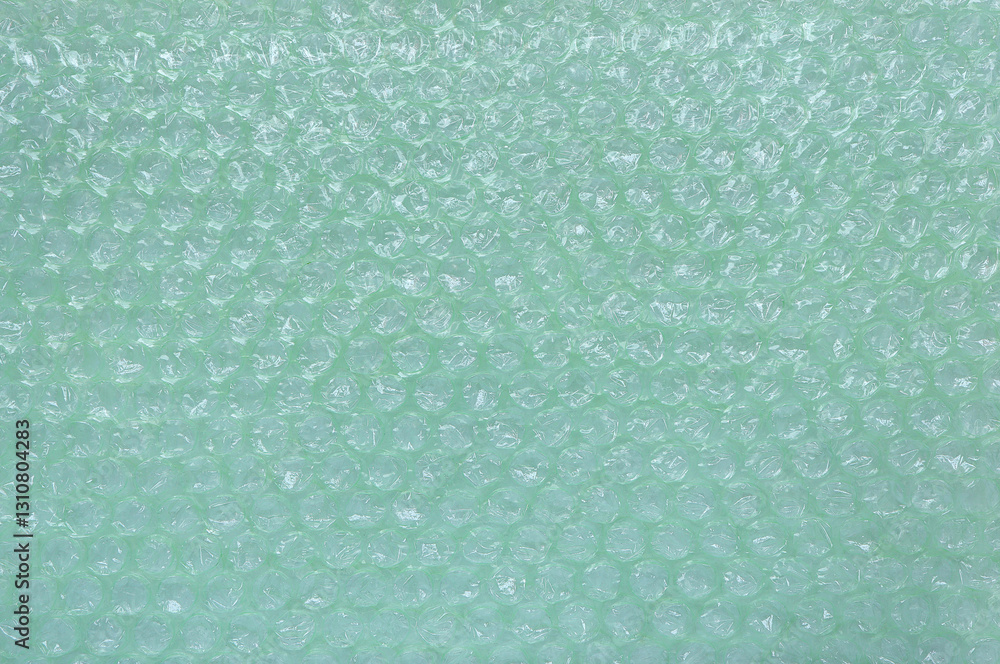Fototapeta premium Green plastic bubble wrap texture background, Polyethylene bubble wrap, above view