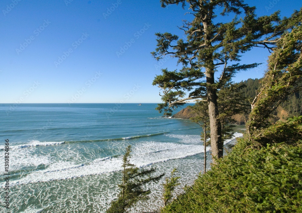 View of Oregon pacific ocean coastline including a shallow sandy beach covered with wave swells on a clear sunny. View of Oregon pacific ocean coastline including a shallow sandy beach covered with wave swells on a clear sunny.
