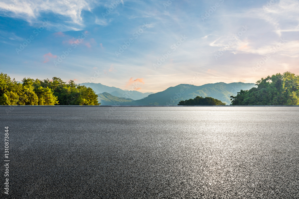 Asphalt road and green forest with mountains nature landscape at sunset