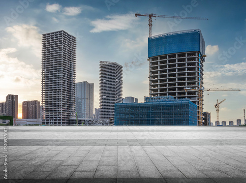 Modern Urban Development at Sunset with Construction Cranes
