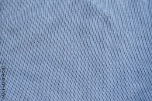 Texture of turquoise blue cotton pique fabric. Flat lay style, close up. Commonly use for t- shirt. Woven fabric characterized by a pattern of raised parallel cords or geometric designs. 