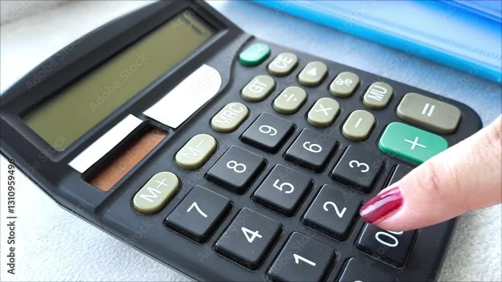 A woman's hand counts the numbers on a calculator. The accountant's job. Financial statistics. Economic development. Mortgage. Taxes. Retirement savings. Calculations. A woman's hand counts the numbers on a calculator. The accountant's job. Financial statistics. Economic development. Mortgage. Taxes. Retirement savings. Calculations.