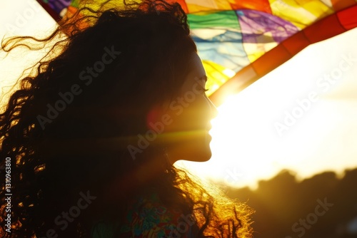 Elegant female face in the sunset dancing with a kite, kite fabric background.