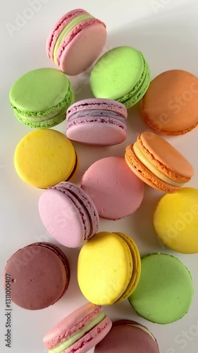 top view of multicolored macaroons on a white background