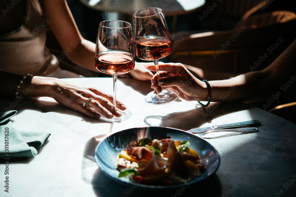 Glasses of rose wine seen during a friendly party or a celebration in a restaurant of a bar.