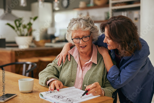 Принти на полотні Senior woman solving crossword puzzle with the help of her daughter