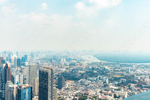 Bangkok, Thailand - Febuary 2, 2025: BTS Chong Nonsi interchange skywalk, Sky Transit, Urban view with dusk air
