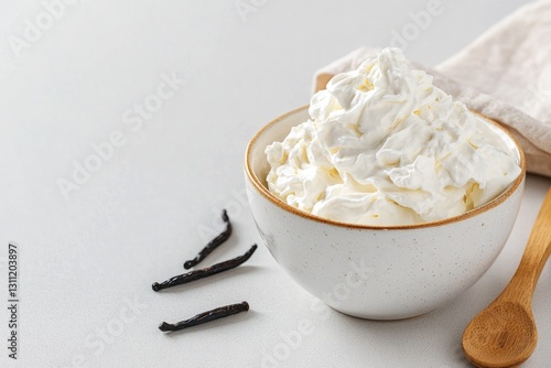 Whipped cream in rustic bowl with vanilla pods, evoking comfort