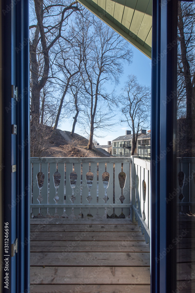 Fototapeta premium Scenic Wooden Balcony Overlooking Residential Neighborhood Under Clear Blue Sky