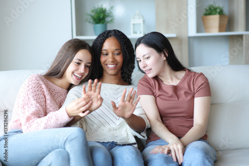 Φωτογραφία Three happy women looking at friend manicure at home