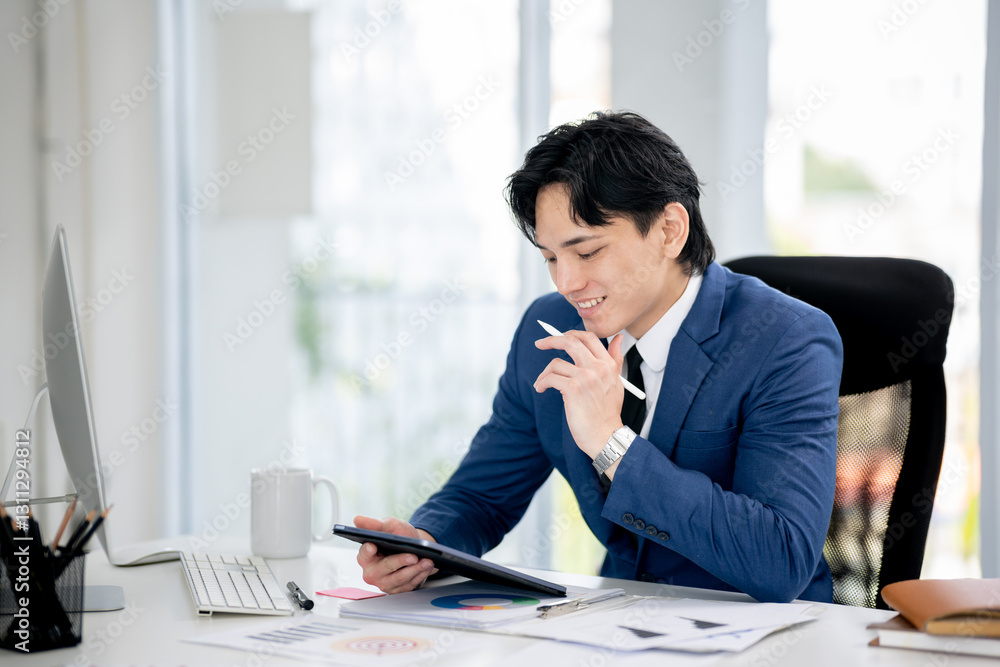 Businessman sitting and working in an office Businessman sitting and working in an office