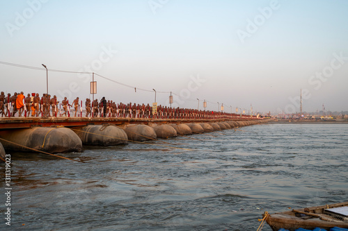 Prayagraj,India-27 pJanuary 2025 Newly made Saint Naga Sadhu going to his tent from Pipa Bridge or pontoon bridge at the Kumbh Mela in Prayagraj or Allahabad Uttar Pradesh India