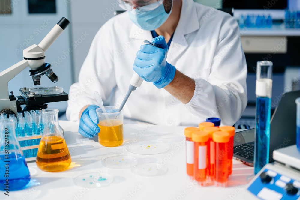 Scientist mixing chemical liquids in the chemistry lab. Researcher working in the laboratory Scientist mixing chemical liquids in the chemistry lab. Researcher working in the laboratory