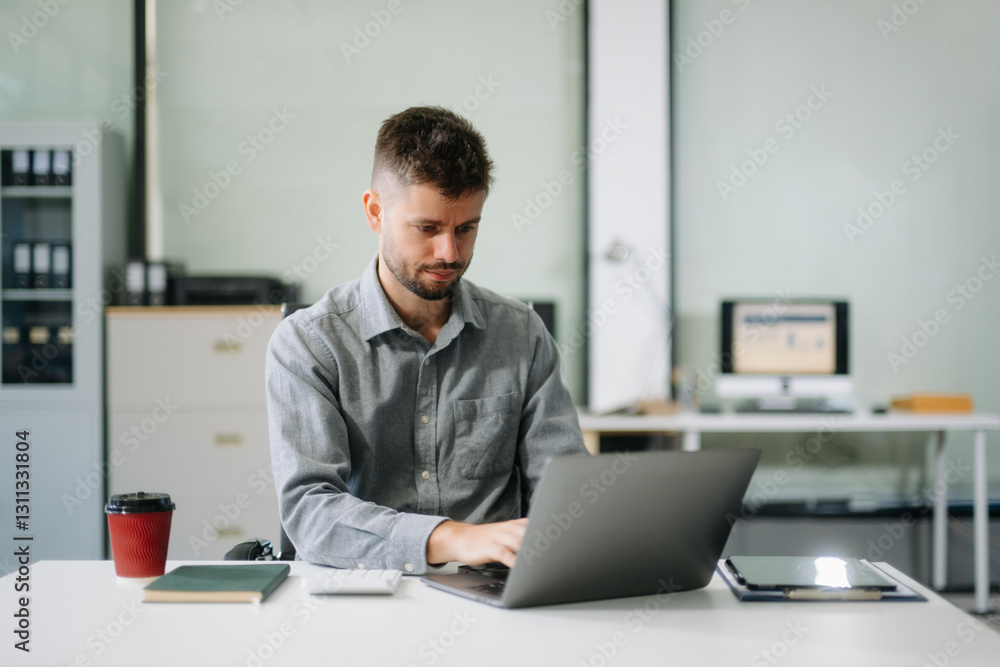 Confident businessman working on finance analysis with a tablet and laptop at office desk. professional workplace concepts.. Confident businessman working on finance analysis with a tablet and laptop at office desk. professional workplace concepts..