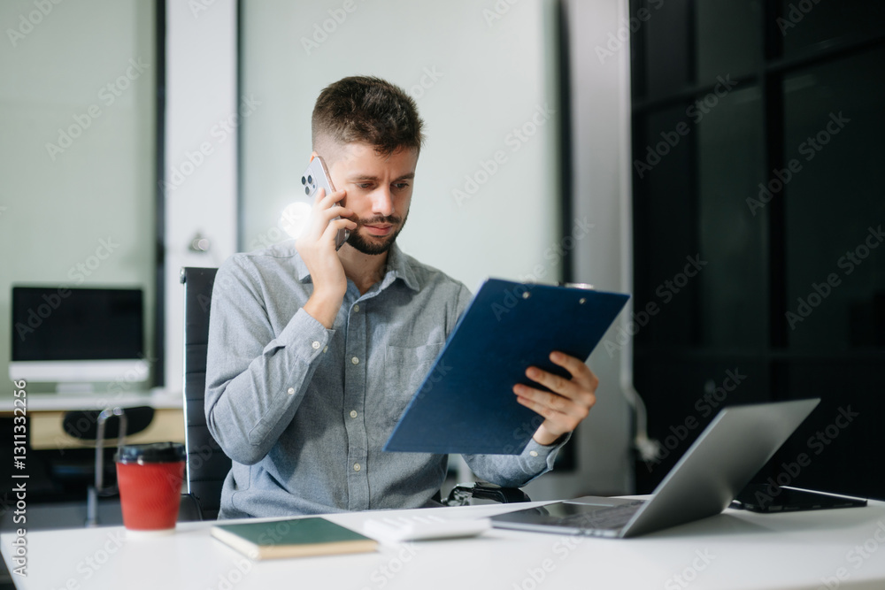 Confident businessman working on finance analysis with a tablet and laptop at office desk. professional workplace concepts.. Confident businessman working on finance analysis with a tablet and laptop at office desk. professional workplace concepts..
