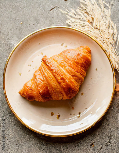Obraz na płótnie Croissant on plate top view fresh pastry social media style w salonie