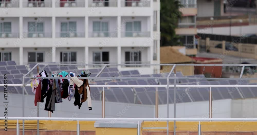 High Rise Daundry Footage of clean clothes drying and pegged on a washing line on top of ...