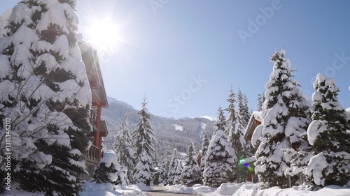 Mountain alpine winter luxury homes with snow covered trees, sunshine, Whistler Canada real estate, ski resort. 4K 24FPS