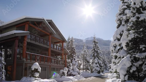 Mountain alpine winter luxury homes with snow covered trees, sunshine, Whistler Canada real estate, ski resort. 4K 24FPS