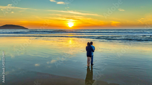 Obraz na płótnie Silhouette of a Couple love toghether on beach at sunset, Vietnam w salonie