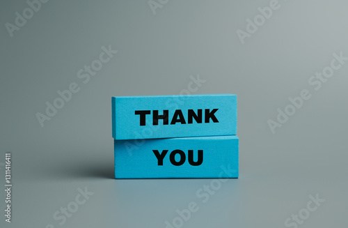 Symbol with word thank you, Wooden block and text on gray background, Positive communication, Business and thank you concept. copy space	