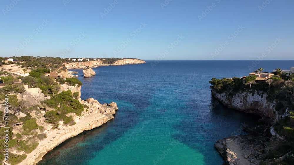 Drone flying back over sea revealing beautiful beach Cala Llombards on Mallorca Drone flying back over sea revealing beautiful beach Cala Llombards on Mallorca