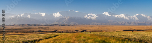 Scenic rural landscape panorama after sunrise of snowcapped Trans Alay mountain range with Lenin peak, Sary Mogul, Kyrgyzstan