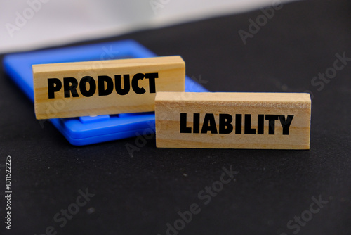 Product liability message written on wooden blocks with black background. Conceptual product liability symbol. Copy space.