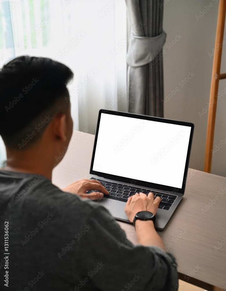 young man using computer laptop in front of an blank white computer screen young man using computer laptop in front of an blank white computer screen