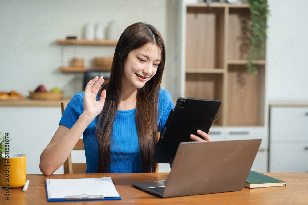 Smiling young woman holding Tablet video call with friend. Smiling young woman holding Tablet video call with friend.