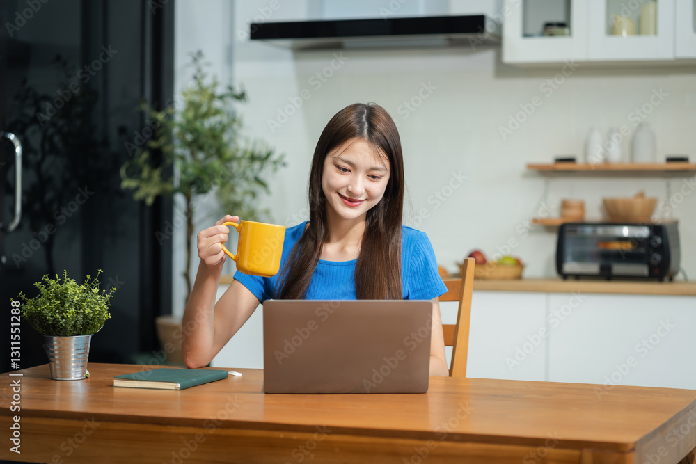 Lifestyle people, using computer working online, doing searching, sitting in the kitchen. Lifestyle people, using computer working online, doing searching, sitting in the kitchen.