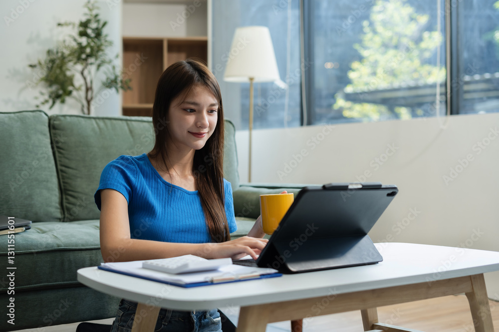 Lifestyle of office workers, young woman calculating expenses and using laptop at home office. Lifestyle of office workers, young woman calculating expenses and using laptop at home office.