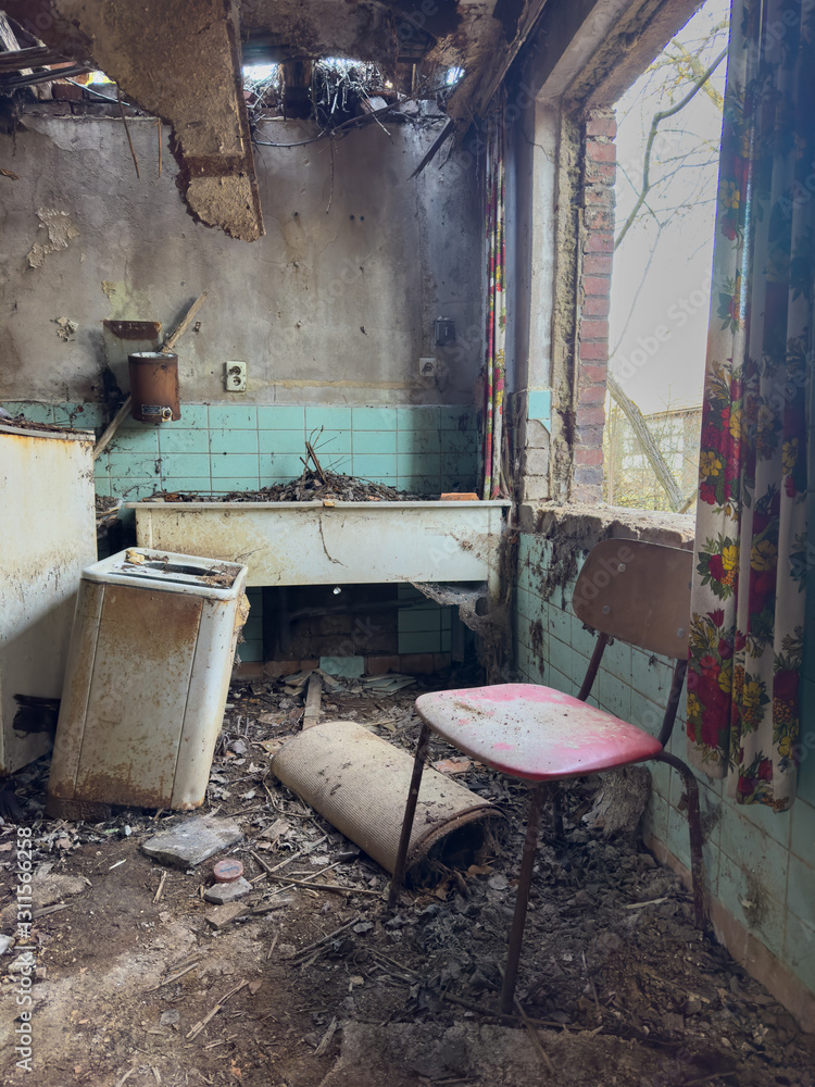 abandoned factory building with red chair and old kitchen appliances in vintage style design vertical