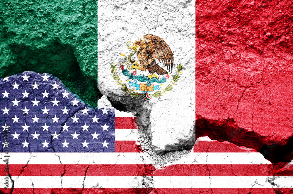 US American and Mexican flags on cracked background. Concept of diplomatic crisis, tariffs and commercial trade war between United States and Mexico
