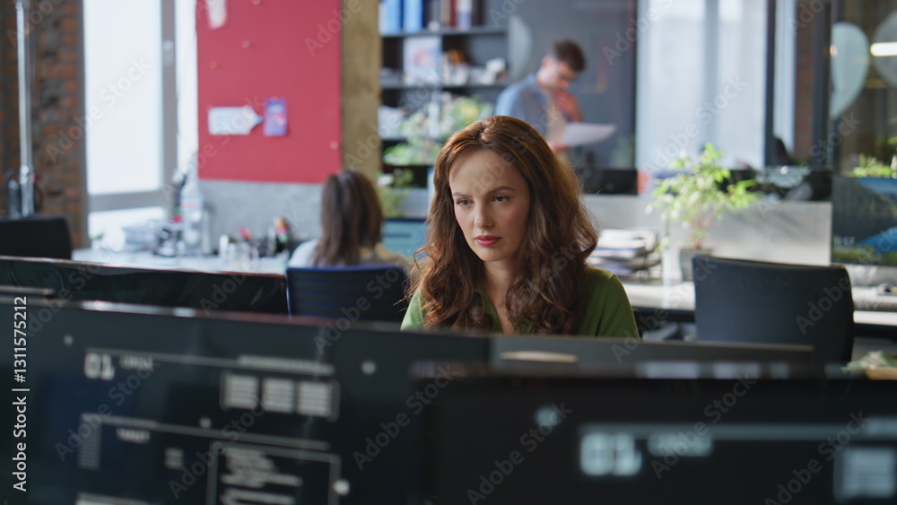 Focused woman staring monitor working at open space closeup. Lady looking camera Focused woman staring monitor working at open space closeup. Lady looking camera
