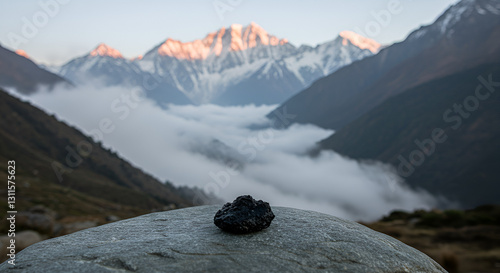 A serene nature scene with Shilajit resin resting on a flat stone, surrounded by Himalayan mountains and misty air to represent its origin and purity: Shilajit, pure, rock, lake, stone, landscape, sno