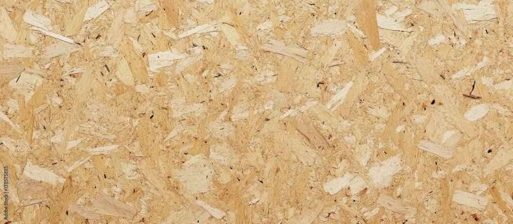 Light beige oriented strand board with a textured chipboard surface and subtle black specks, ideal for backgrounds, featuring ample copy space.