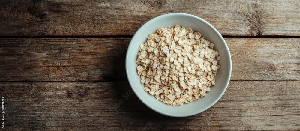 Bowl of raw oatmeal on a rustic wooden table with earthy tones showcasing the oats in a centered position for a natural, wholesome feel. Bowl of raw oatmeal on a rustic wooden table with earthy tones showcasing the oats in a centered position for a natural, wholesome feel.