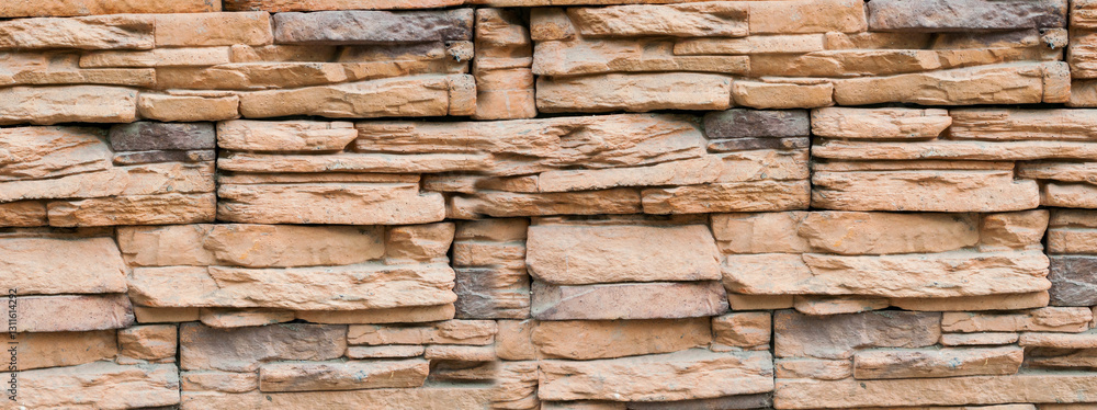 Stone background of decorative stone wall made of sand stone blocks, panorama of stone bricks made of sand Stone background of decorative stone wall made of sand stone blocks, panorama of stone bricks made of sand