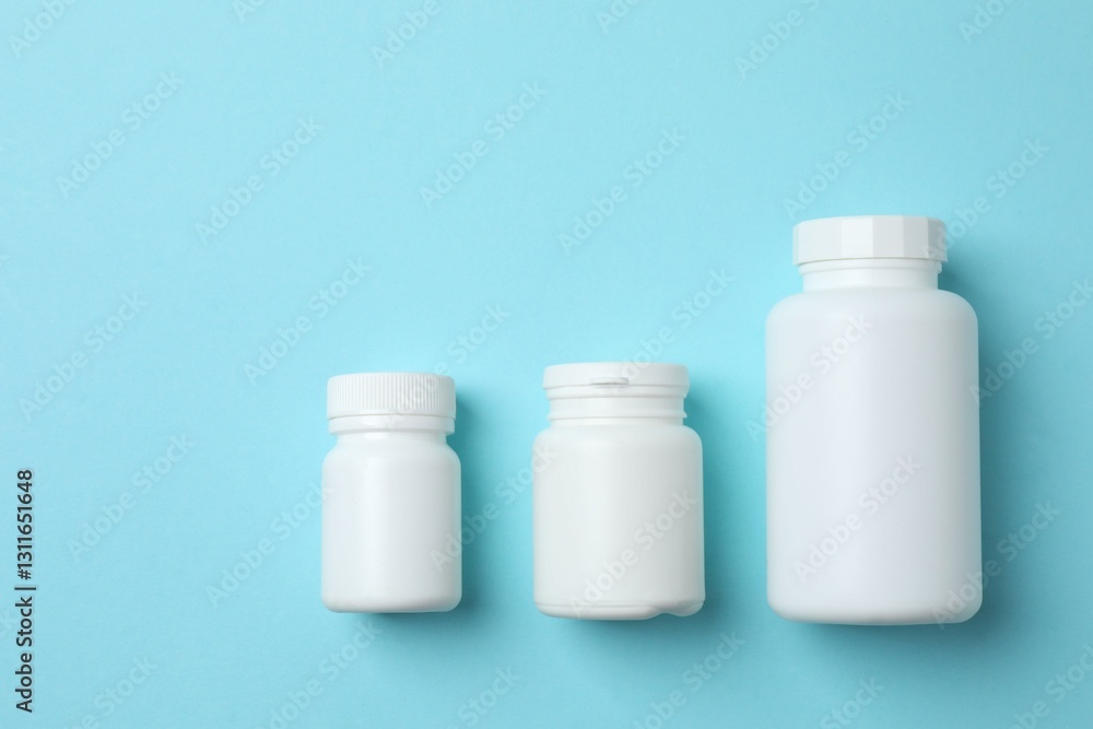 White bottles on blue background, top view White bottles on blue background, top view