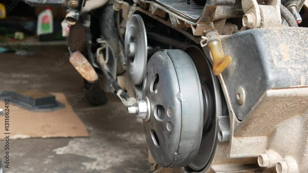 A mechanic performs repairs, maintenance and cleaning on a motorbike CVT A mechanic performs repairs, maintenance and cleaning on a motorbike CVT