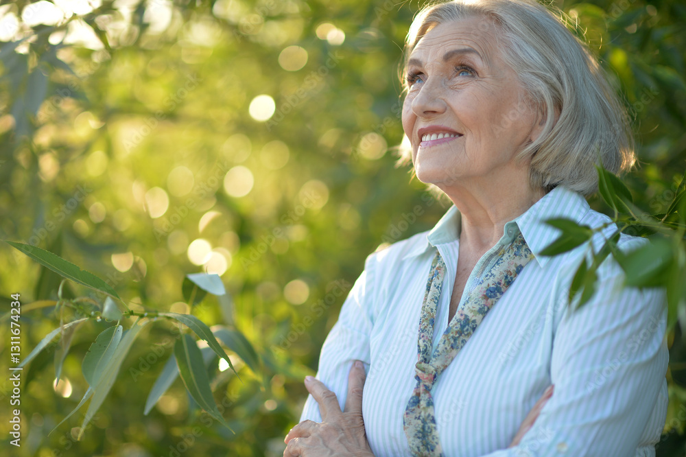 Portrait of a beautiful elderly woman in the park