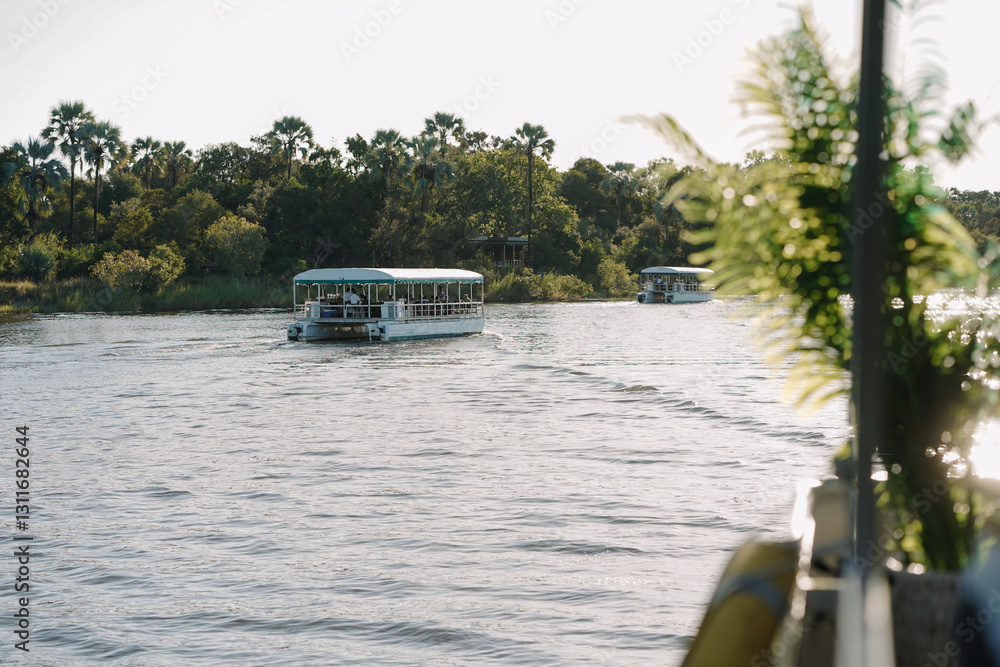 Naklejka premium Tourists enjoying a cruise on the Zambezi River in Zimbabwe