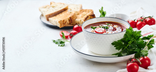 Wallpaper Mural Tomato puree soup garnished with parsley, feta cheese and spices with toasted bread slices, tomatoes and herbs on white table Torontodigital.ca