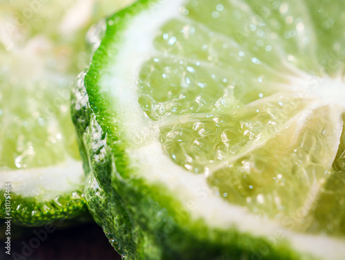 Quadro su tela Macro of slices bergamot fruit  on black background, close-up of slices bergamot