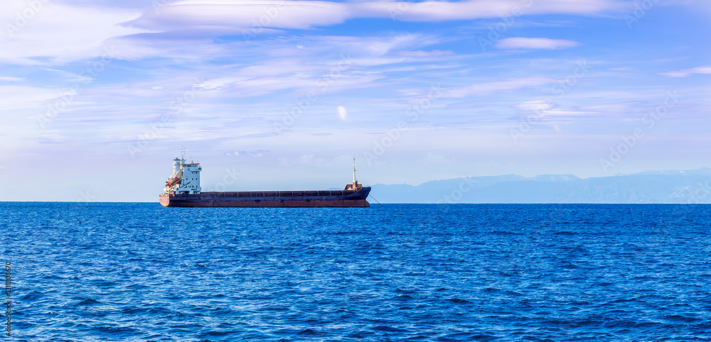 Oil tanker underway towards open sea. Crude oil tanker ship, a merchant ship specially designed for chemical products transportation Oil tanker underway towards open sea. Crude oil tanker ship, a merchant ship specially designed for chemical products transportation