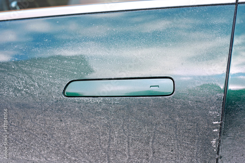 Obraz na płótnie Close-up of dusty car door with modern flush handle, impact of dirt and salt accumulation on vehicle aesthetics and the importance of regular maintenance. Clean car door handle, selective focus. w salonie