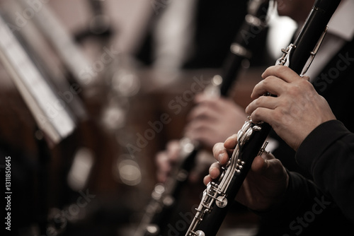 Hands of a musician playing the clarinet in an orchestra